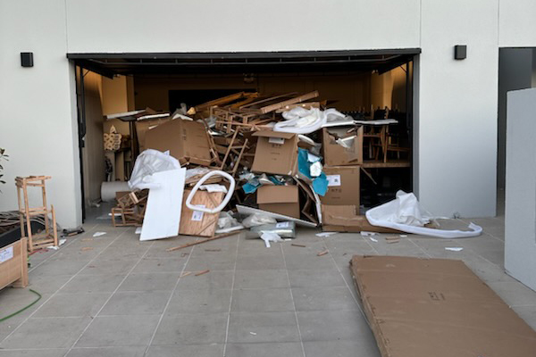Garage packed with junk — King's Birthday junk removal sale