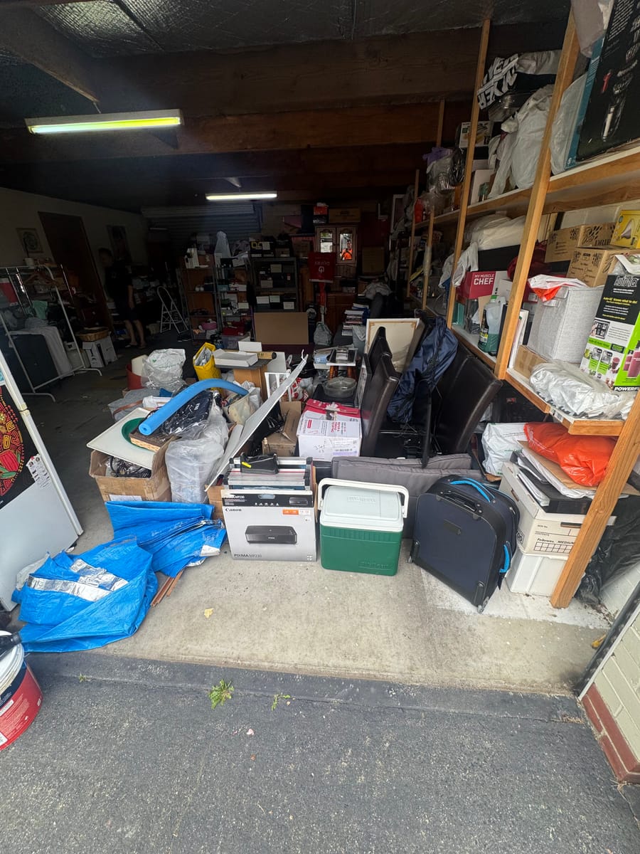 Garage packed with boxes and clutter before a garage cleanout in Melbourne