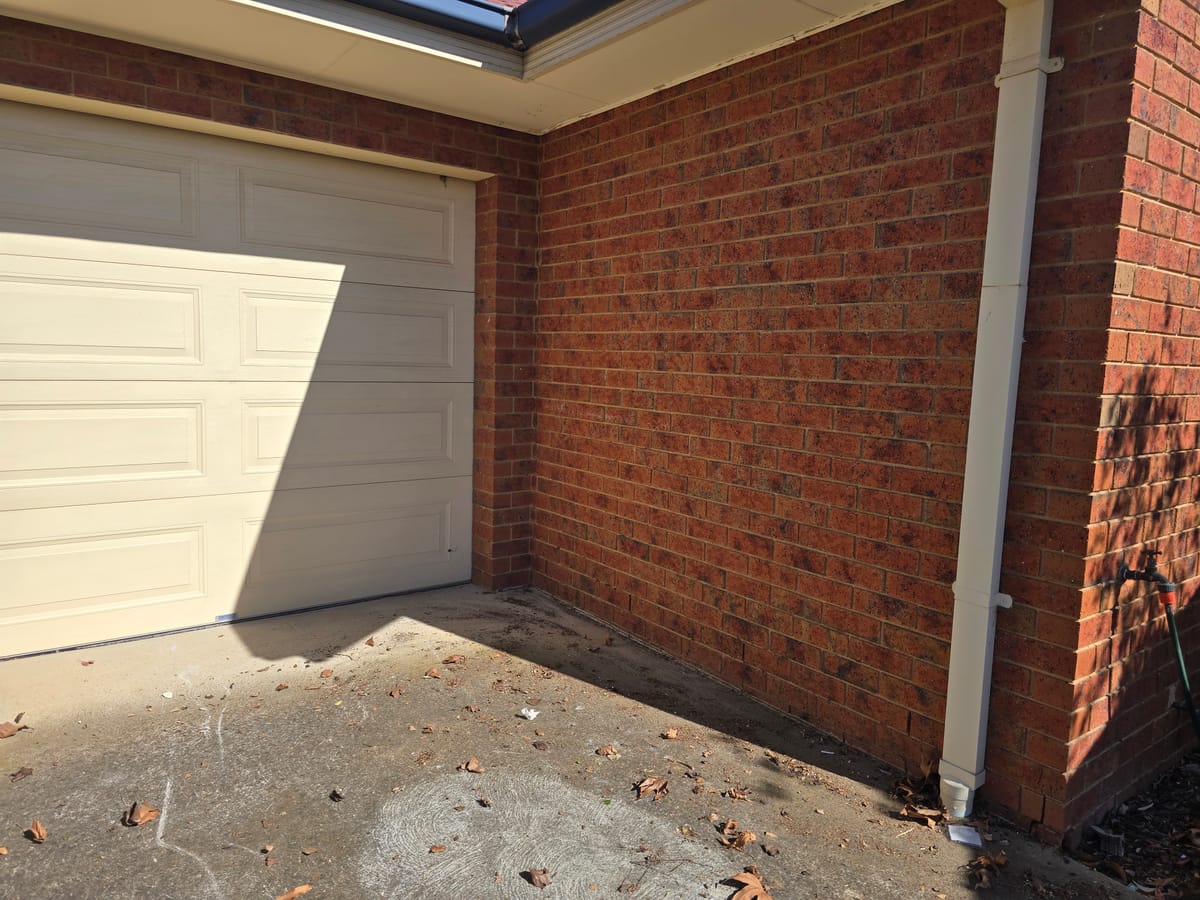 Cleared brick courtyard and garage door after household junk removal in Melbourne