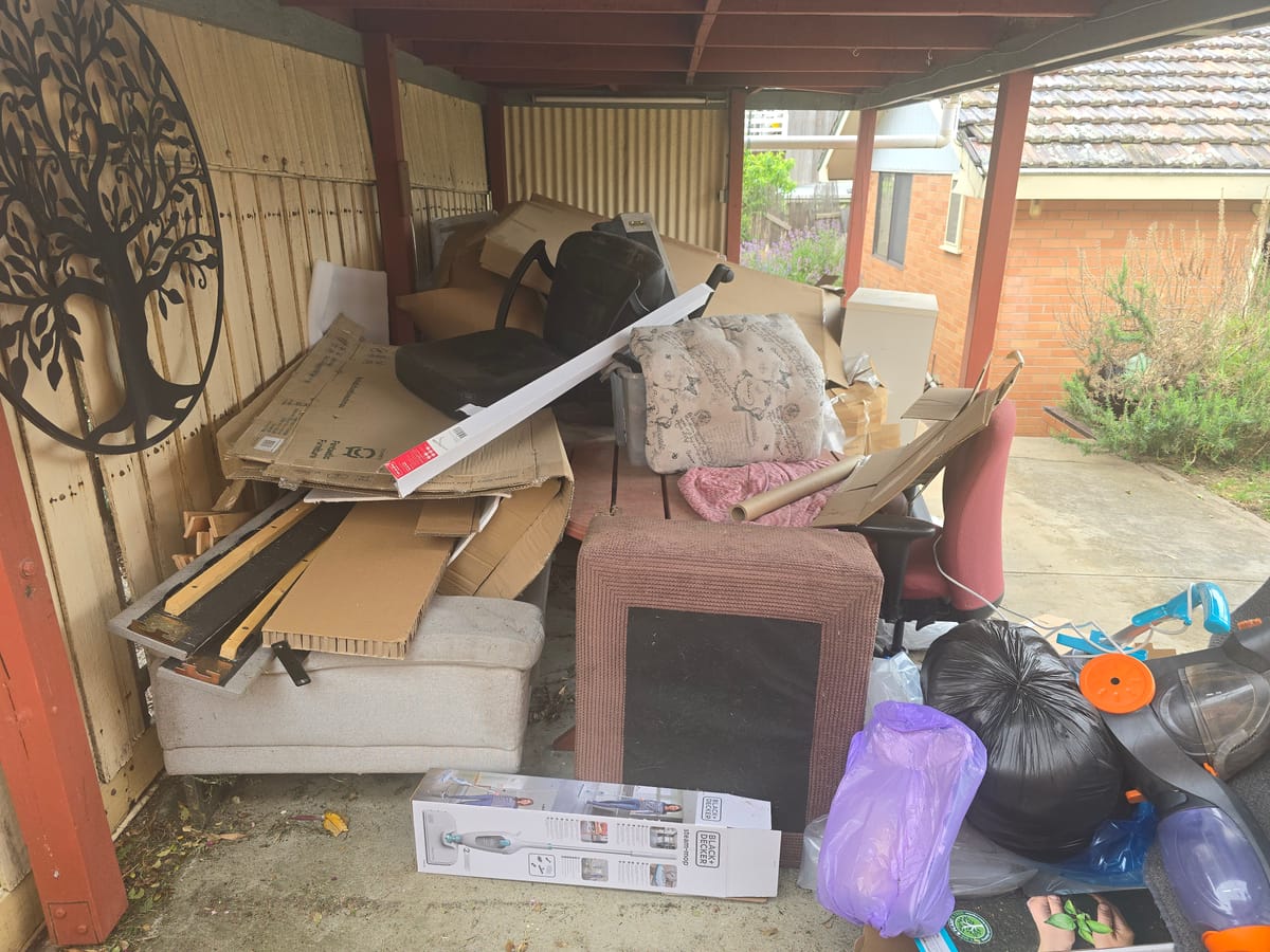 Covered patio full of old furniture and junk before household rubbish removal in Melbourne