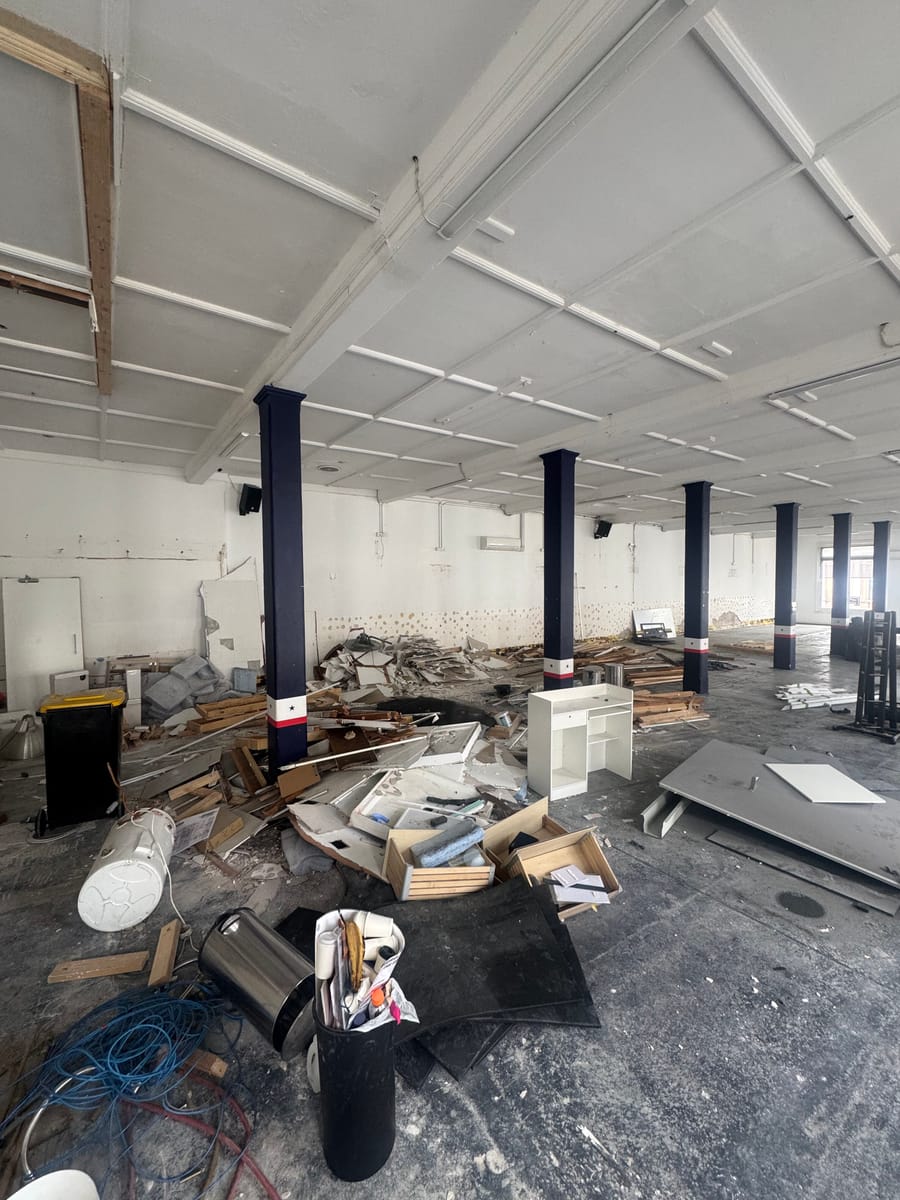 Commercial warehouse floor covered in debris before commercial rubbish removal in Melbourne