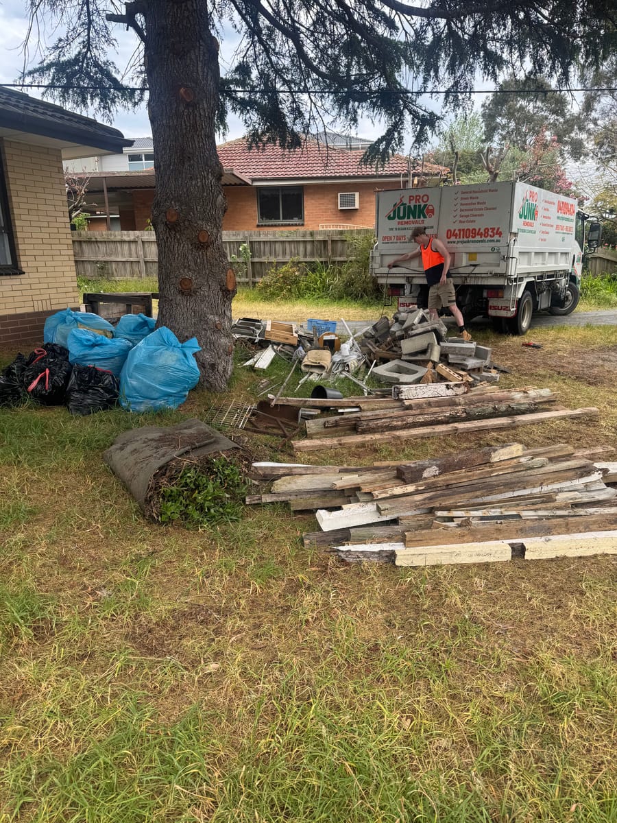 Front yard scattered with renovation timber and offcuts before waste removal in Melbourne